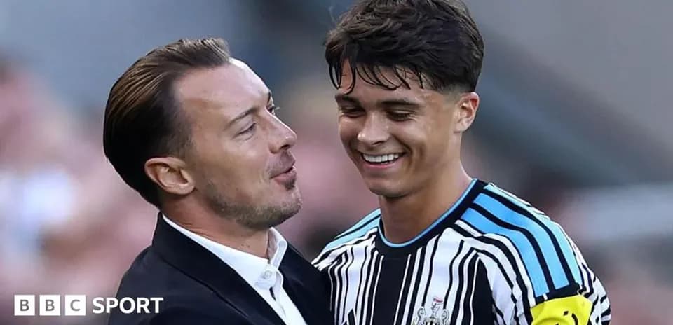 Coach and player celebrating on the pitch
