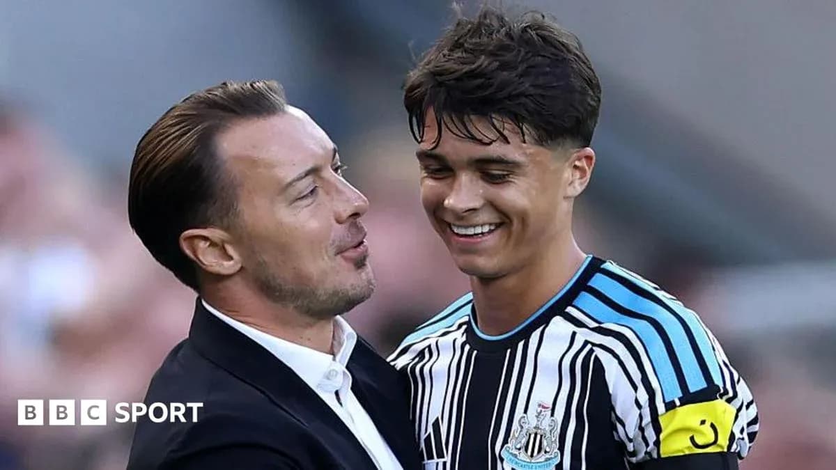 Coach and player celebrating on the pitch