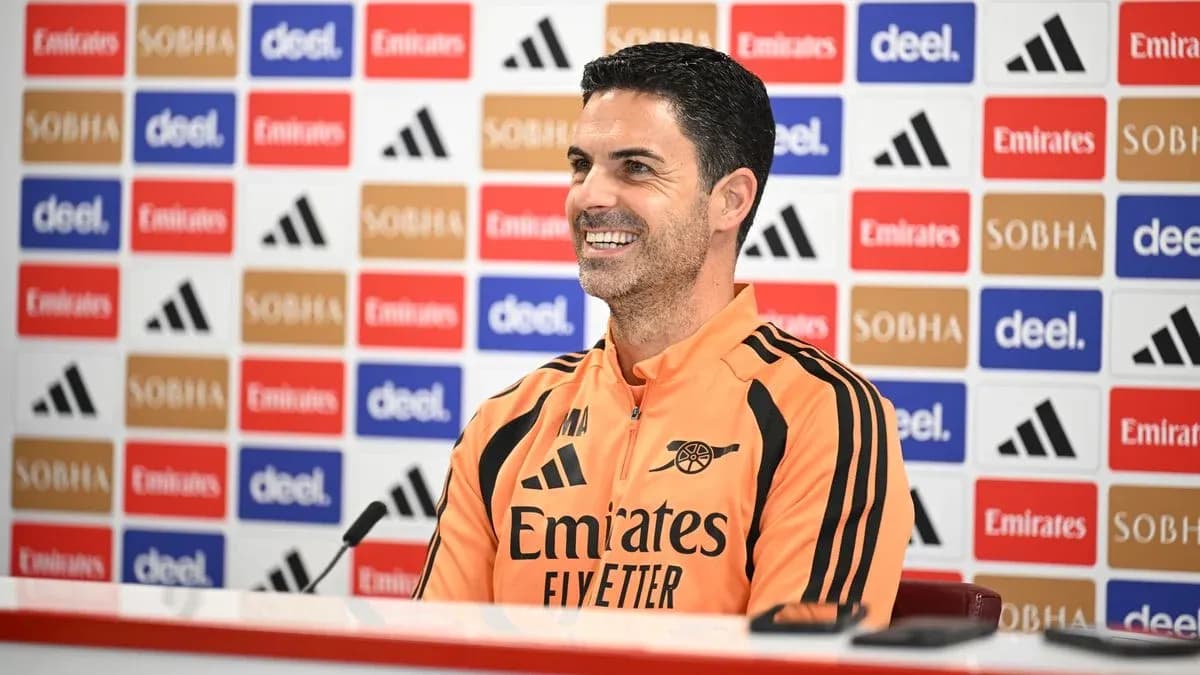 Manager speaking at press conference with sponsor backdrop