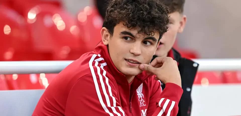 Liverpool player sitting on the bench during match