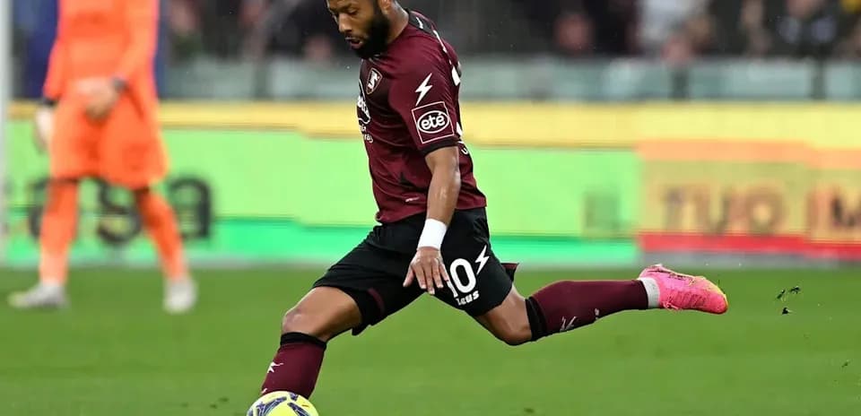 Player kicking a soccer ball during match action