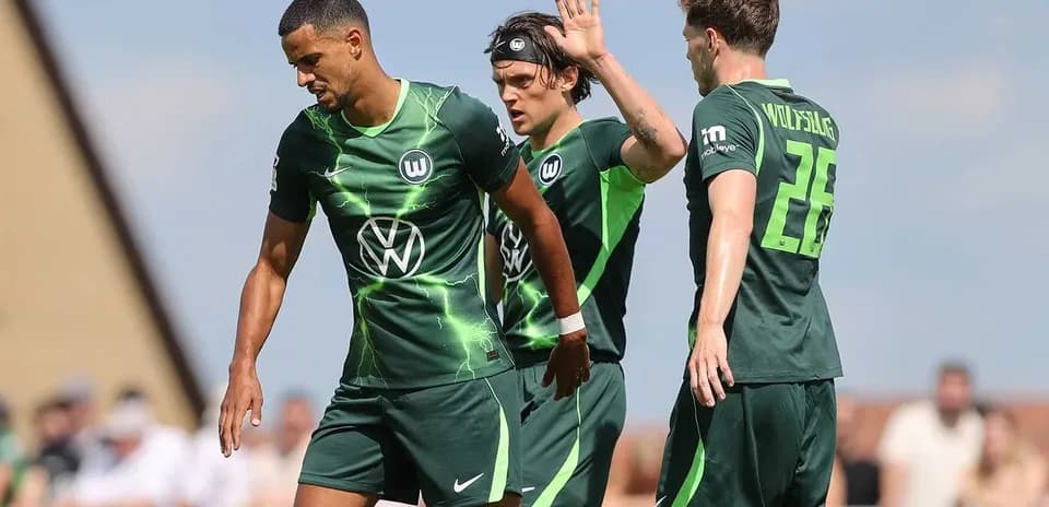 Wolfsburg players interacting during a training session