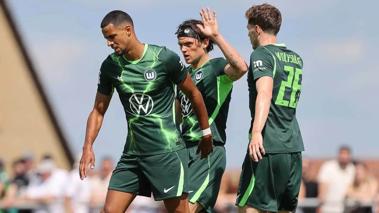 Wolfsburg players interacting during a training session
