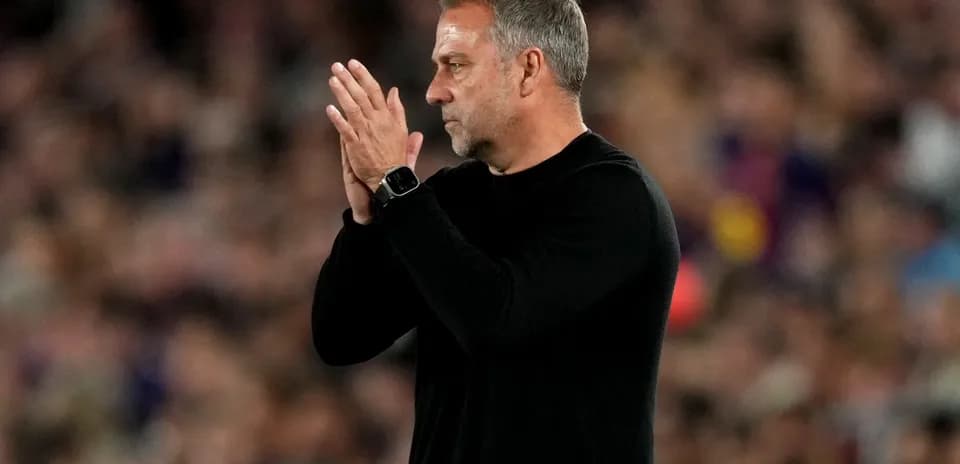Coach applauding during a match at the stadium