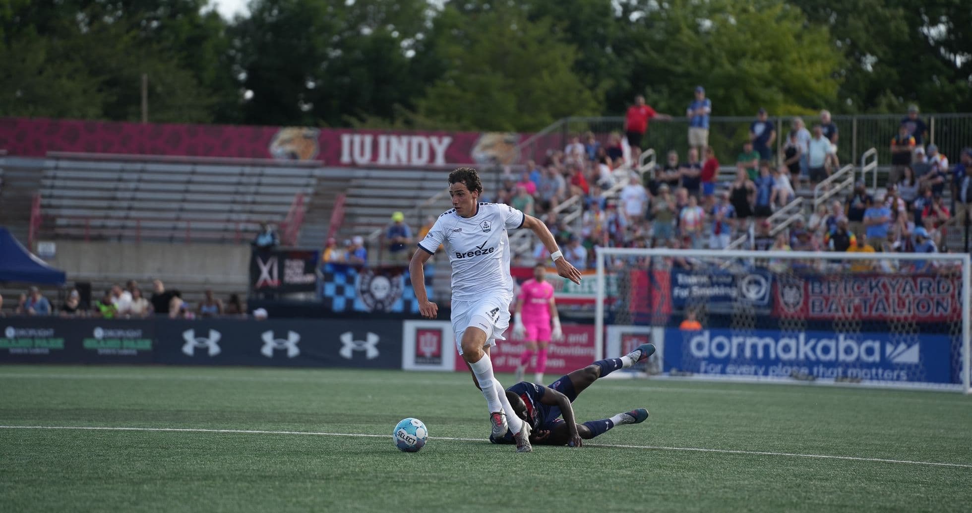 Player dribbling past opponent during match