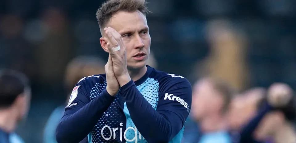 Player applauding fans after a match
