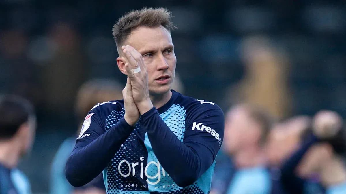 Player applauding fans after a match