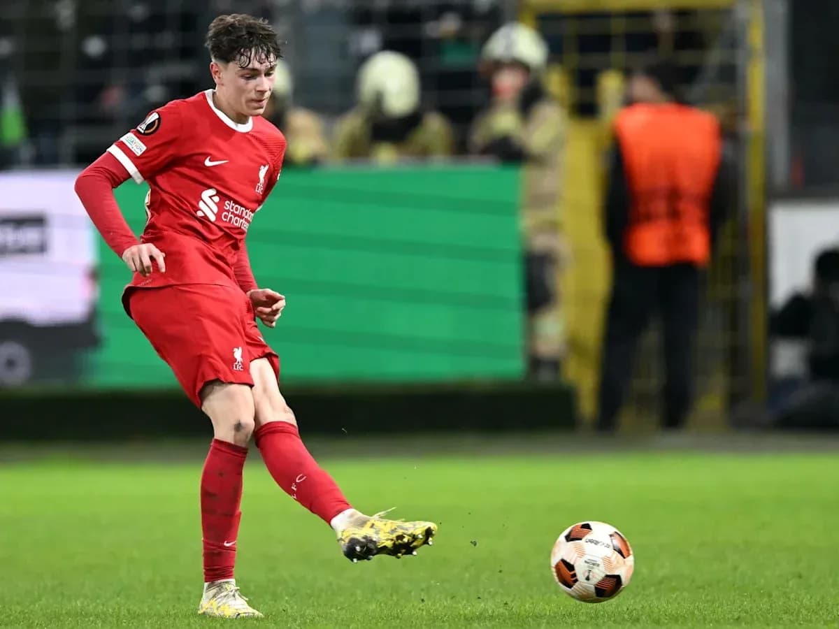 Player kicking ball during match for Liverpool
