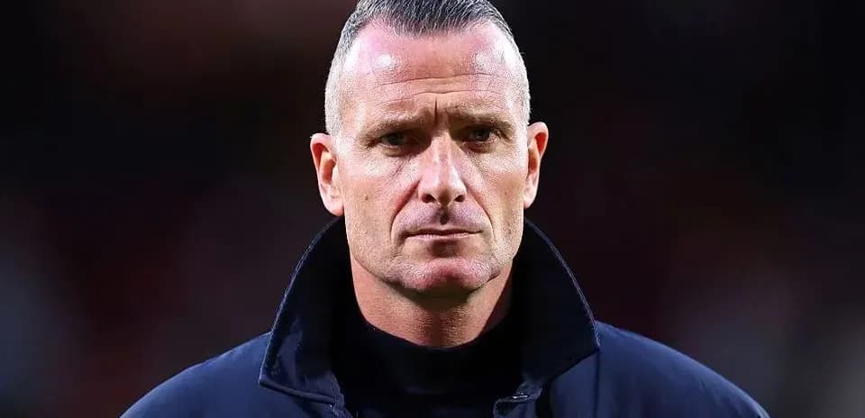 Coach with serious expression during match