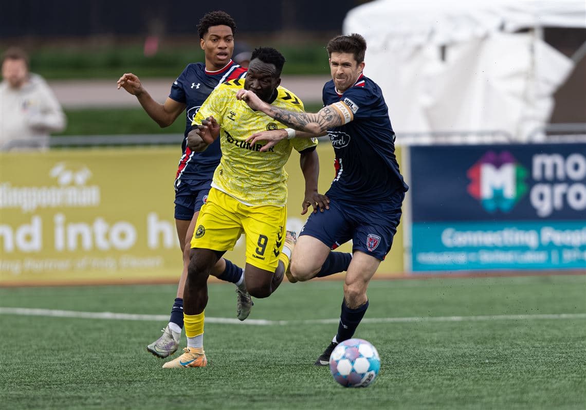 Players contesting for the ball during match