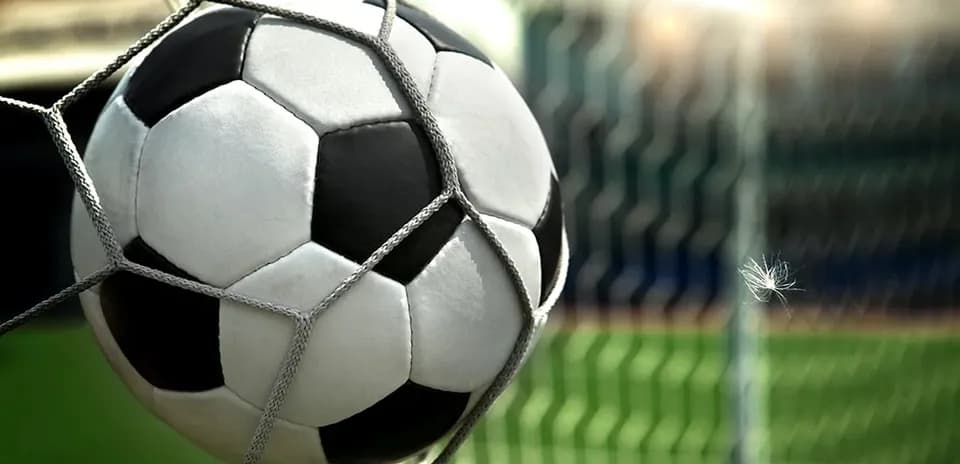 Soccer ball in net after scoring a goal