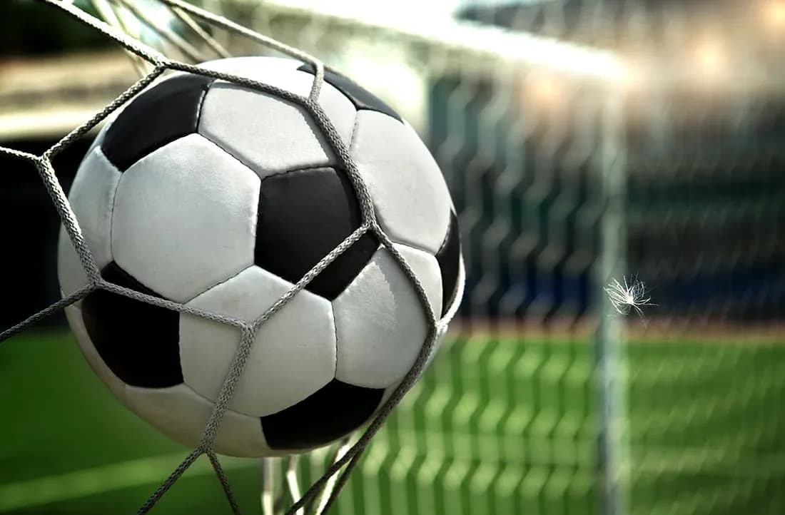 Soccer ball in net after scoring a goal
