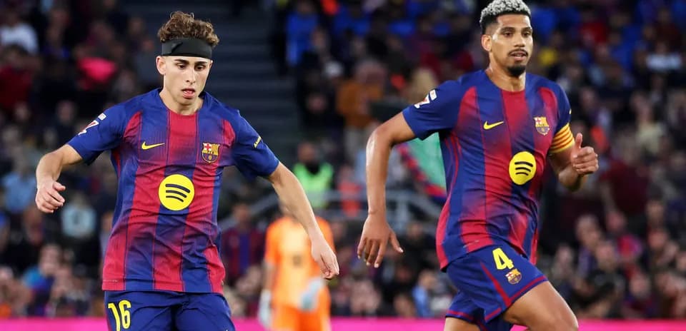 Two FC Barcelona players running during a match