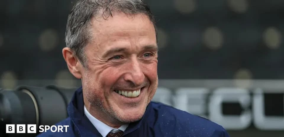 Smiling man in a raincoat during event