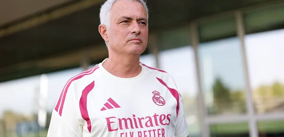Coach wearing Real Madrid training shirt outdoors