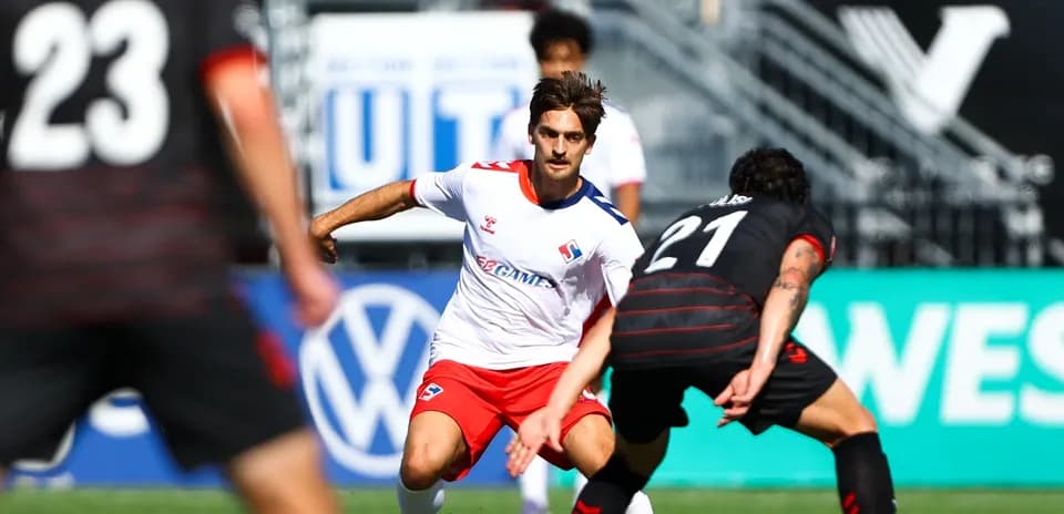 Player dribbling during Vancouver FC match