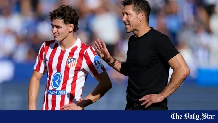 Atletico Madrid player listening to coach during match