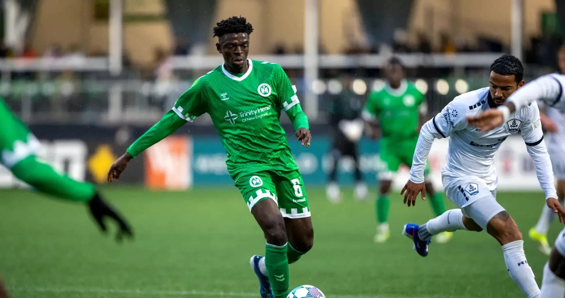 NY Cosmos player dribbling against Hartford Athletic