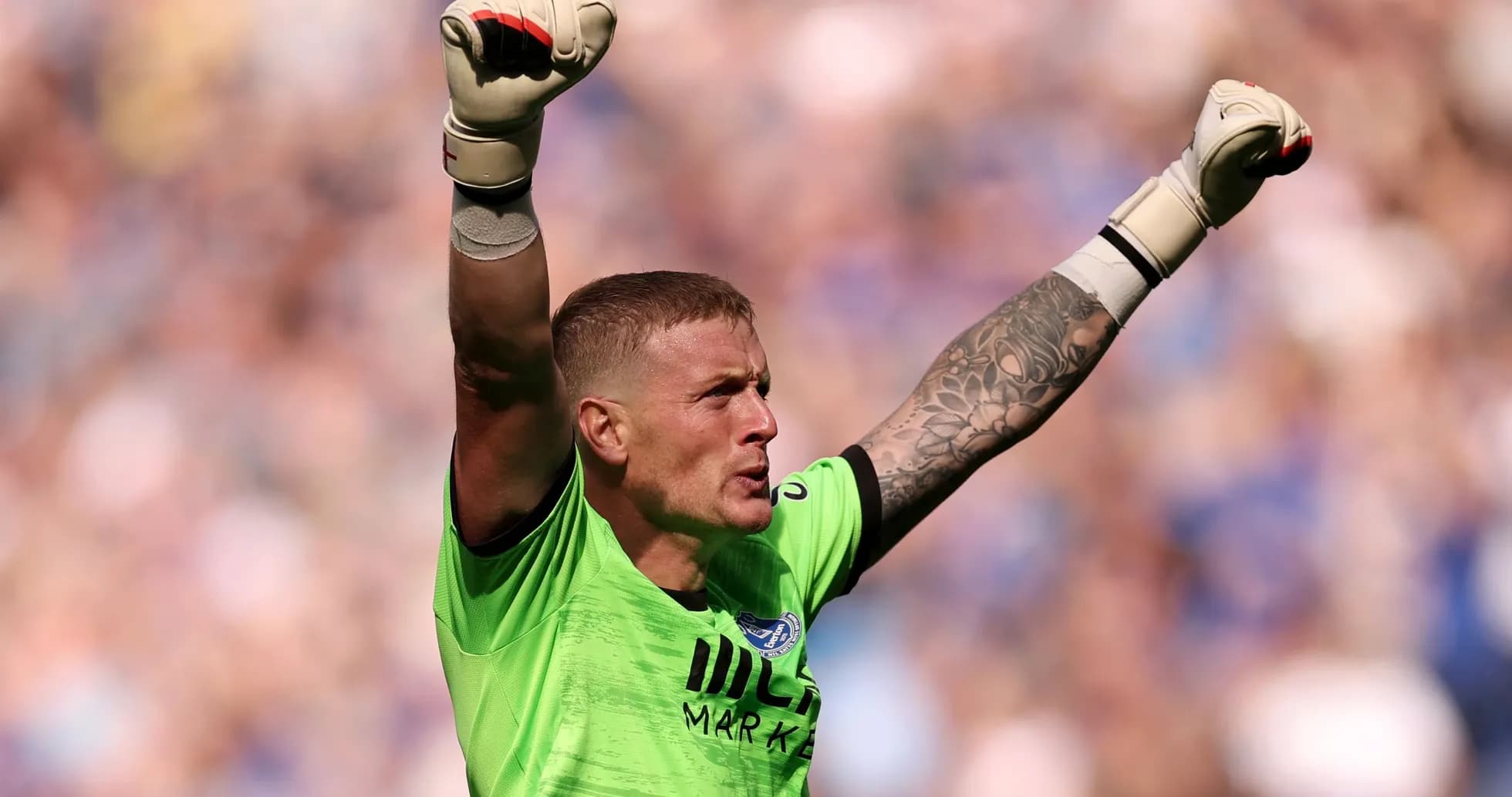 Goalkeeper celebrating with raised arms during match