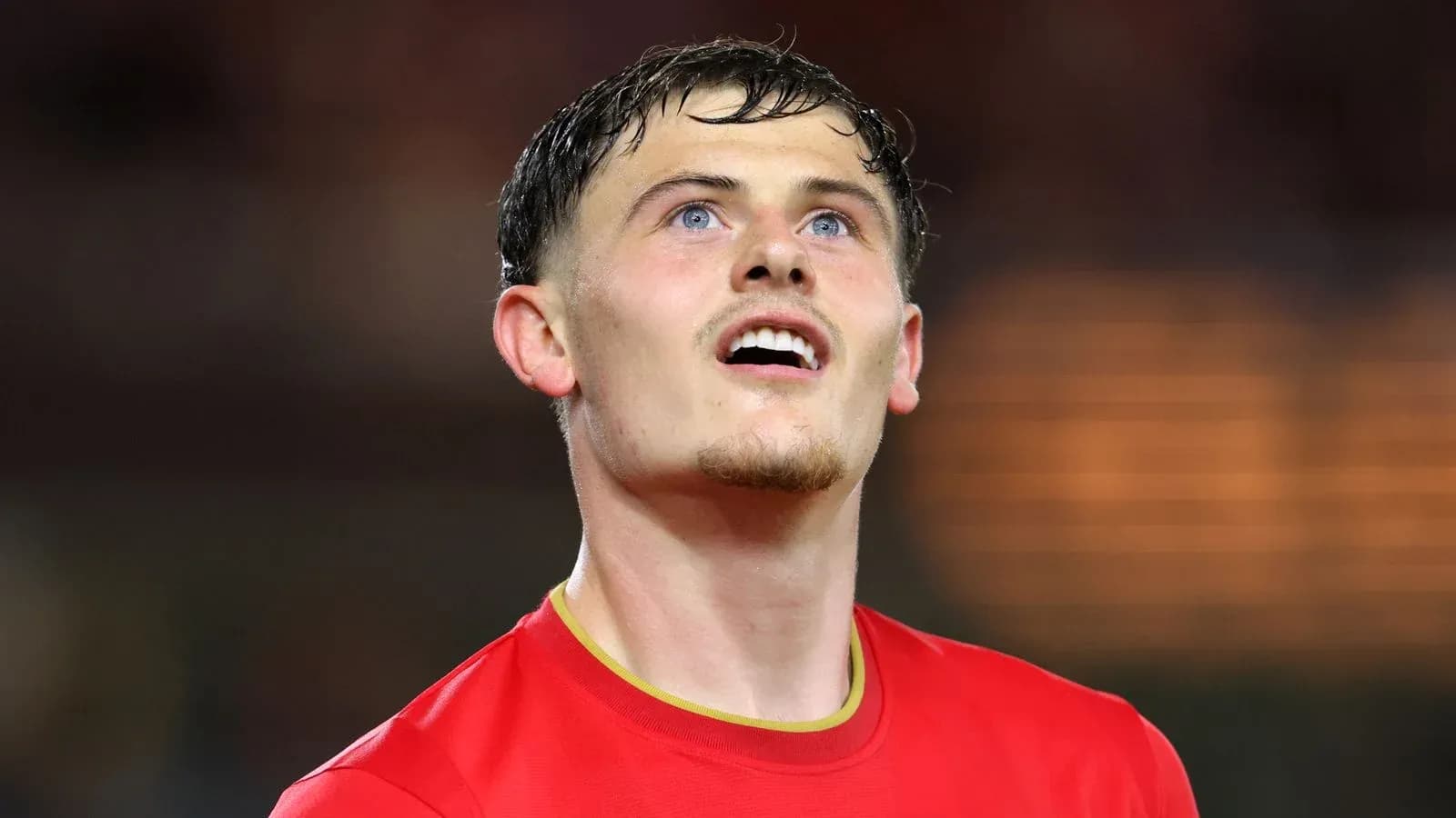Player in red jersey looking upwards during match