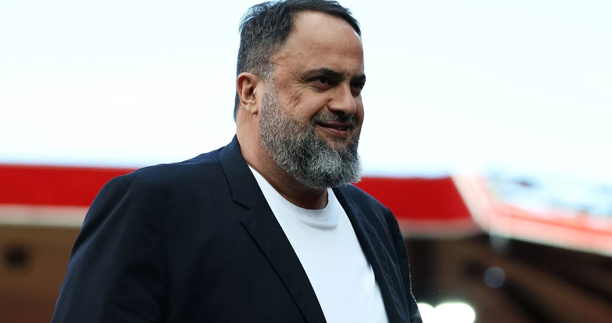 Man with a beard walking in stadium area