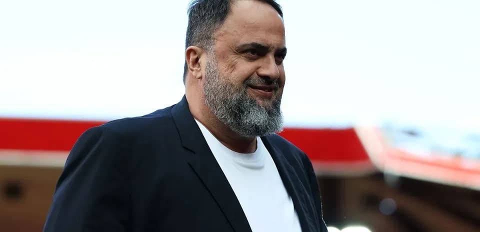 Man with a beard walking in stadium area