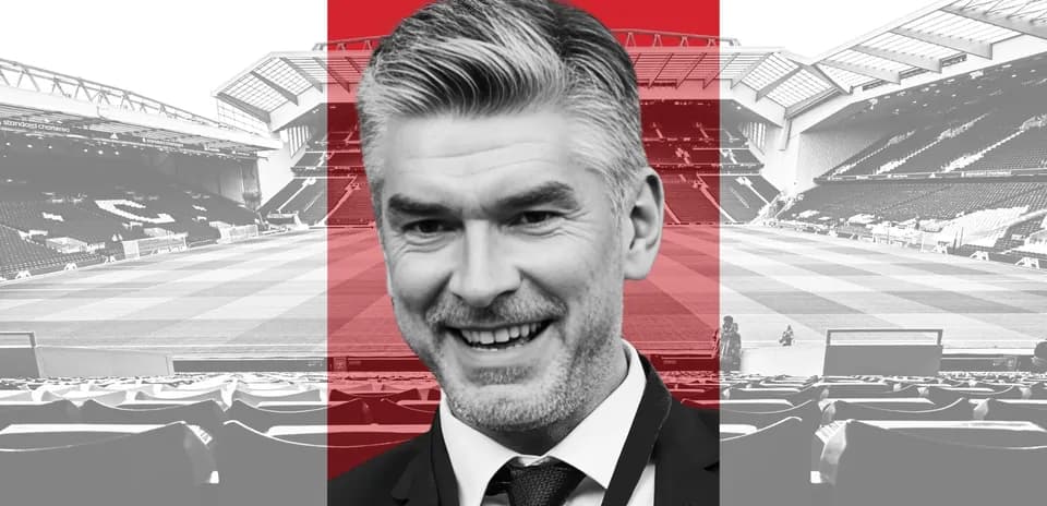 Man smiling in front of football stadium backdrop