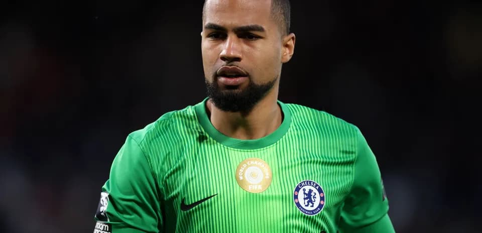 Goalkeeper in green kit during match preparation
