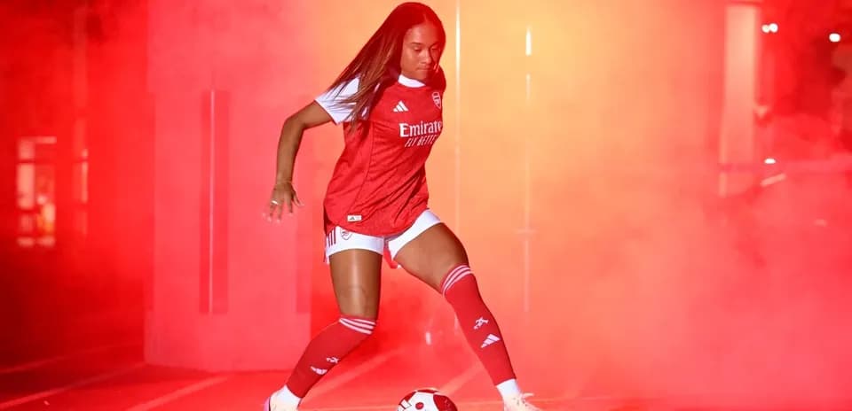 Player dribbling a soccer ball in red fog