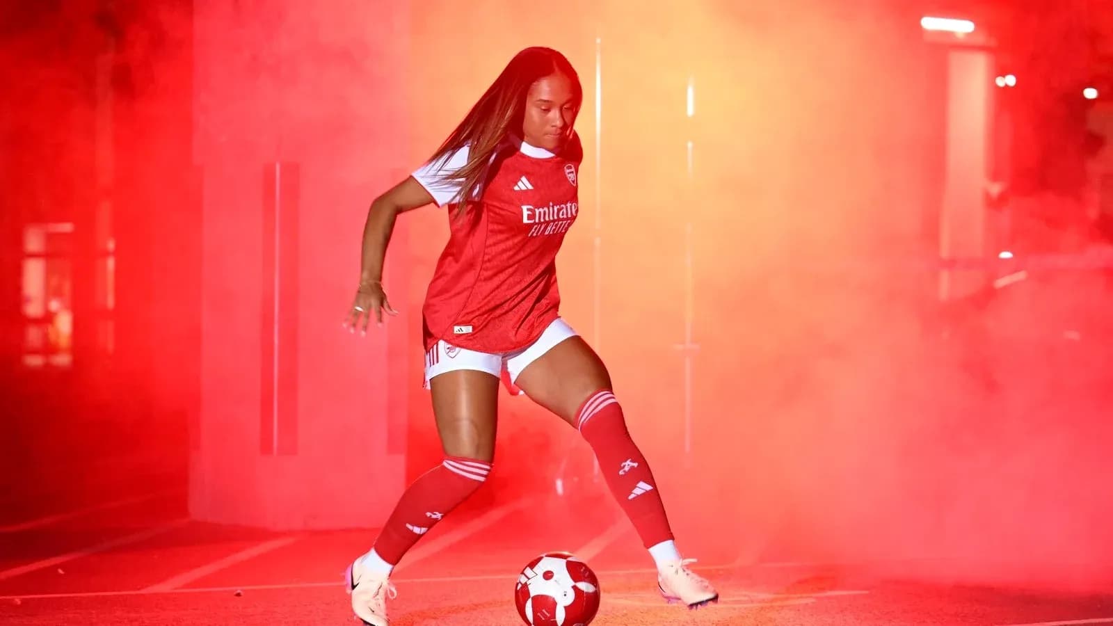 Player dribbling a soccer ball in red fog
