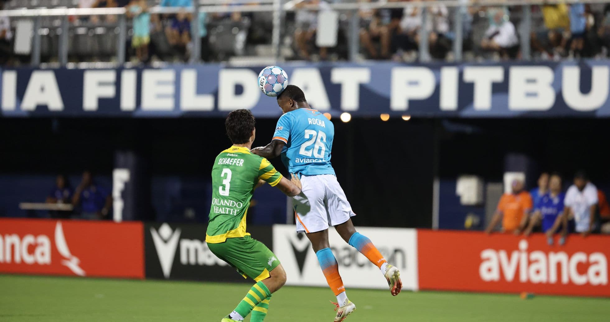 Player heading the ball during match action