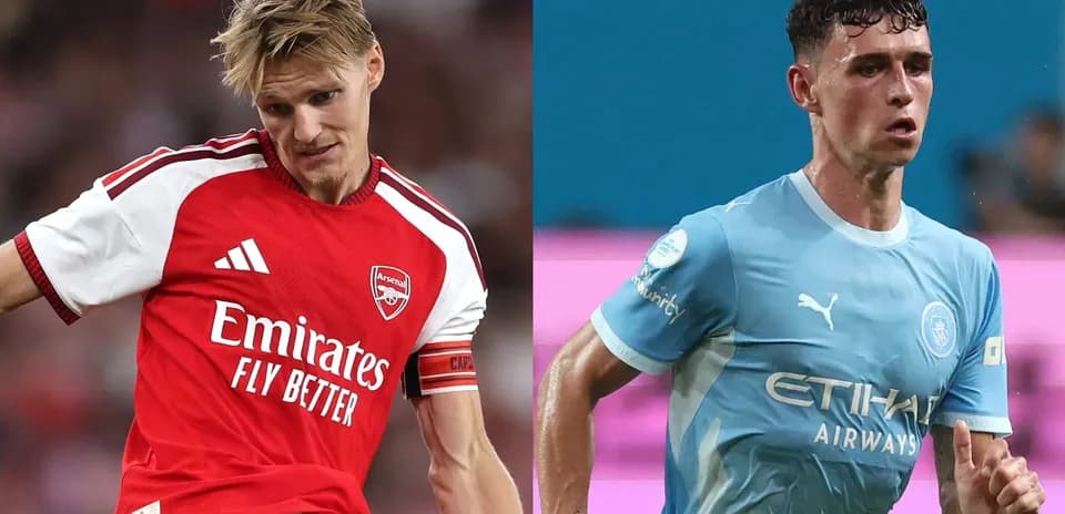 Arsenal and Manchester City players during match action
