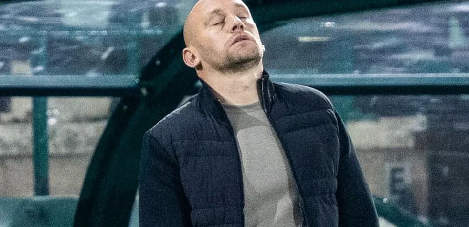 Coach looking pensive on the sideline