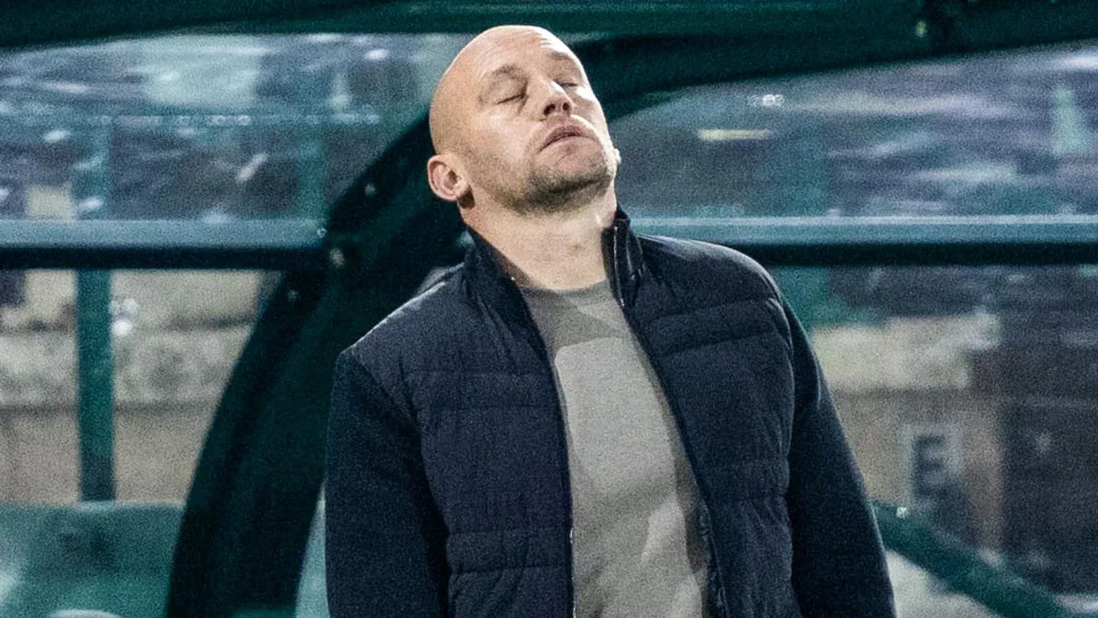 Coach looking pensive on the sideline