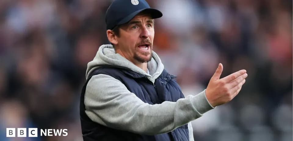 Coach gesturing during a match from the sidelines