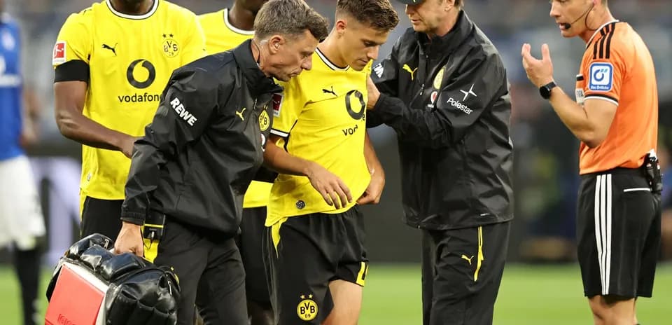 Borussia Dortmund player receiving medical attention during match