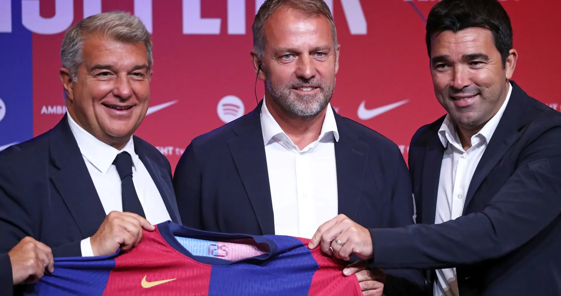 Three officials presenting Barcelona jersey at event