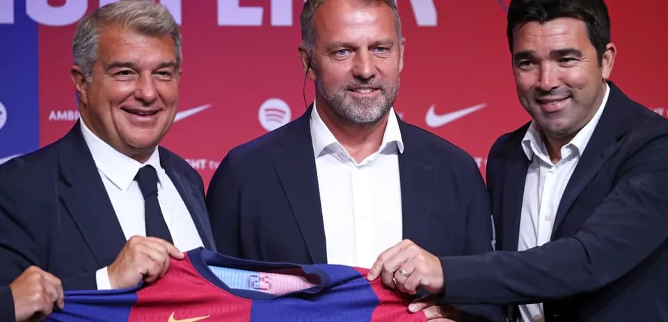 Three officials presenting Barcelona jersey at event