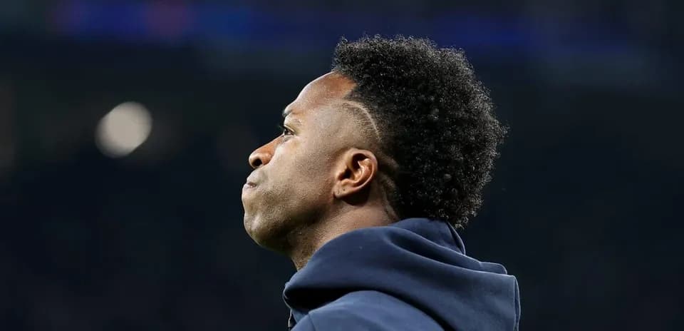 Player looking out during match, wearing hoodie