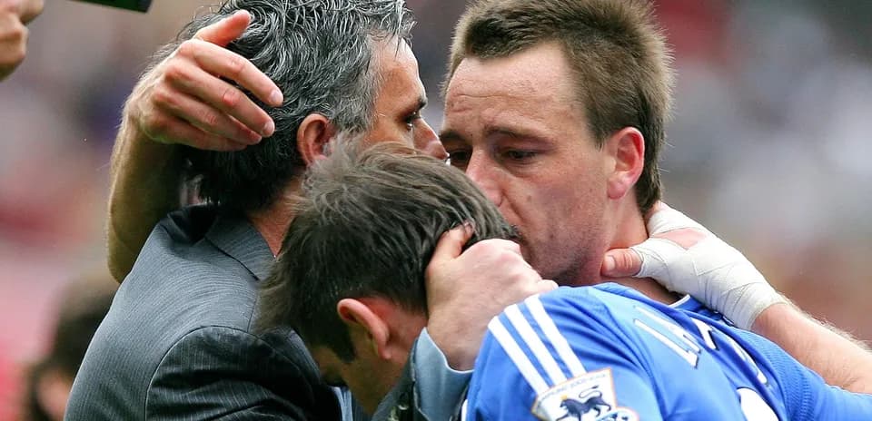 Players and coach embracing on the field