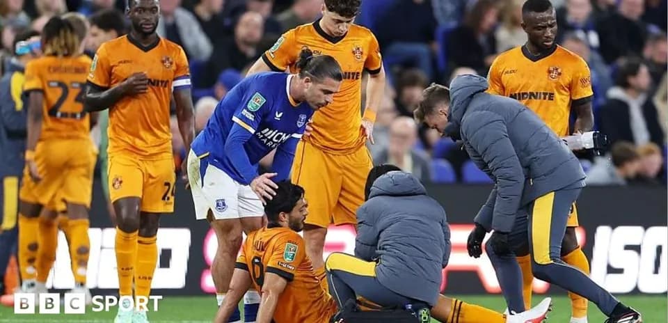 Medical staff attending to injured player on pitch