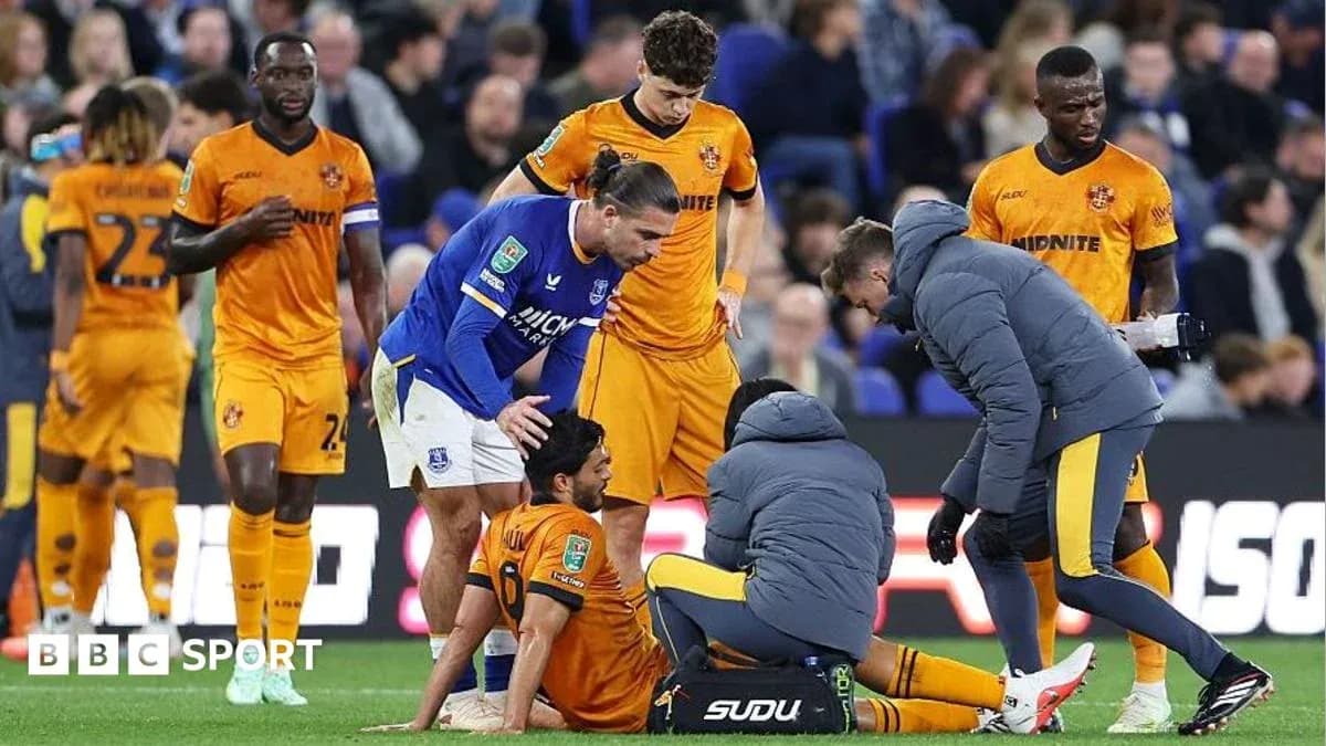 Medical staff attending to injured player on pitch