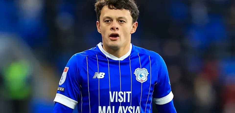Football player in blue kit during match