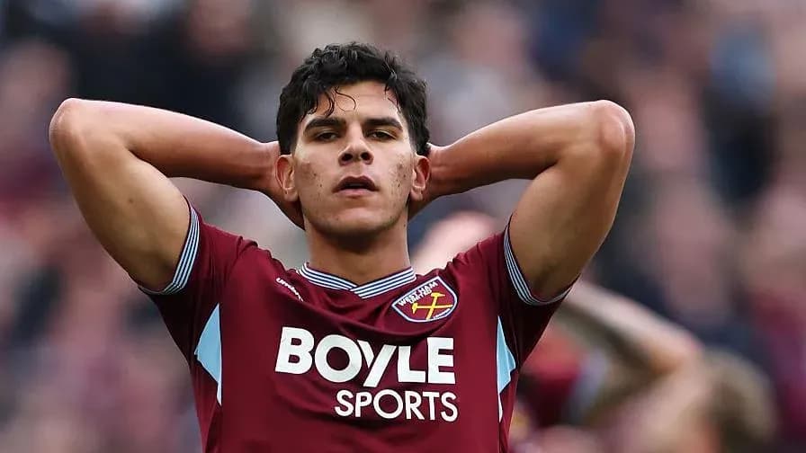 Player in West Ham jersey with hands on head