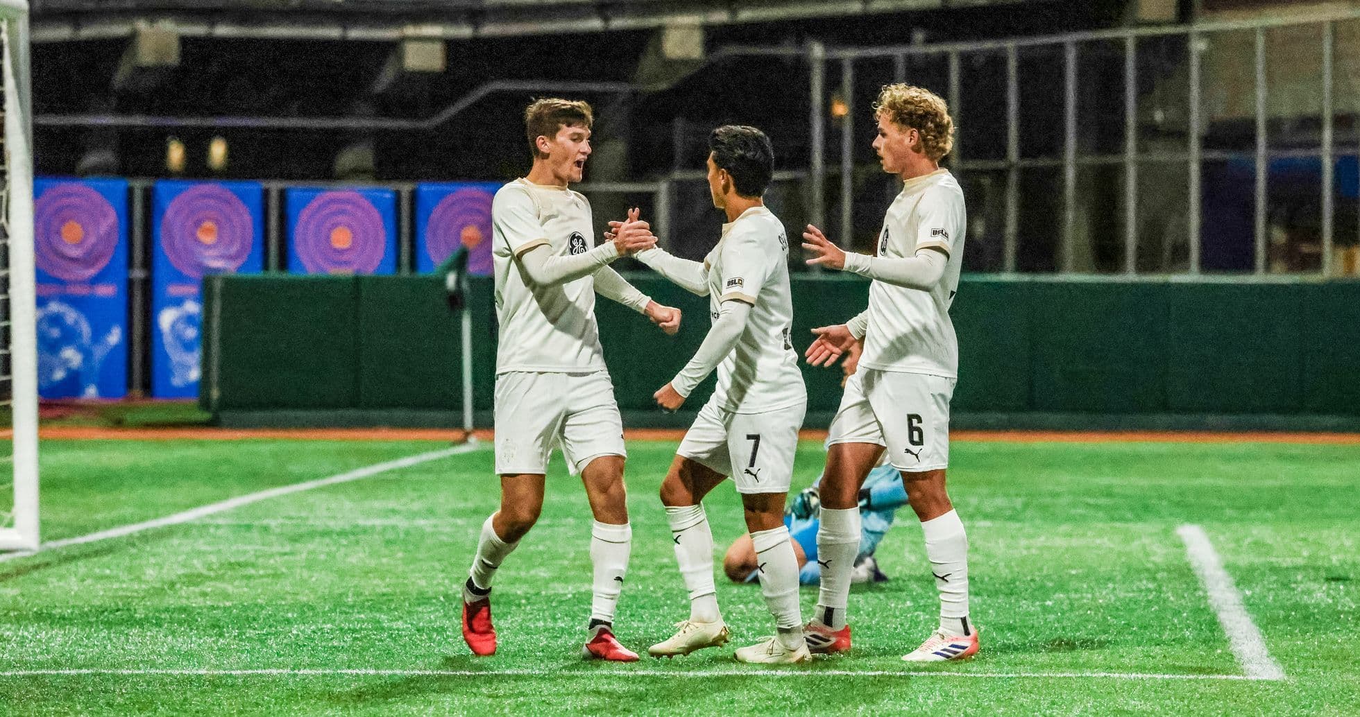 Players celebrating a goal during match