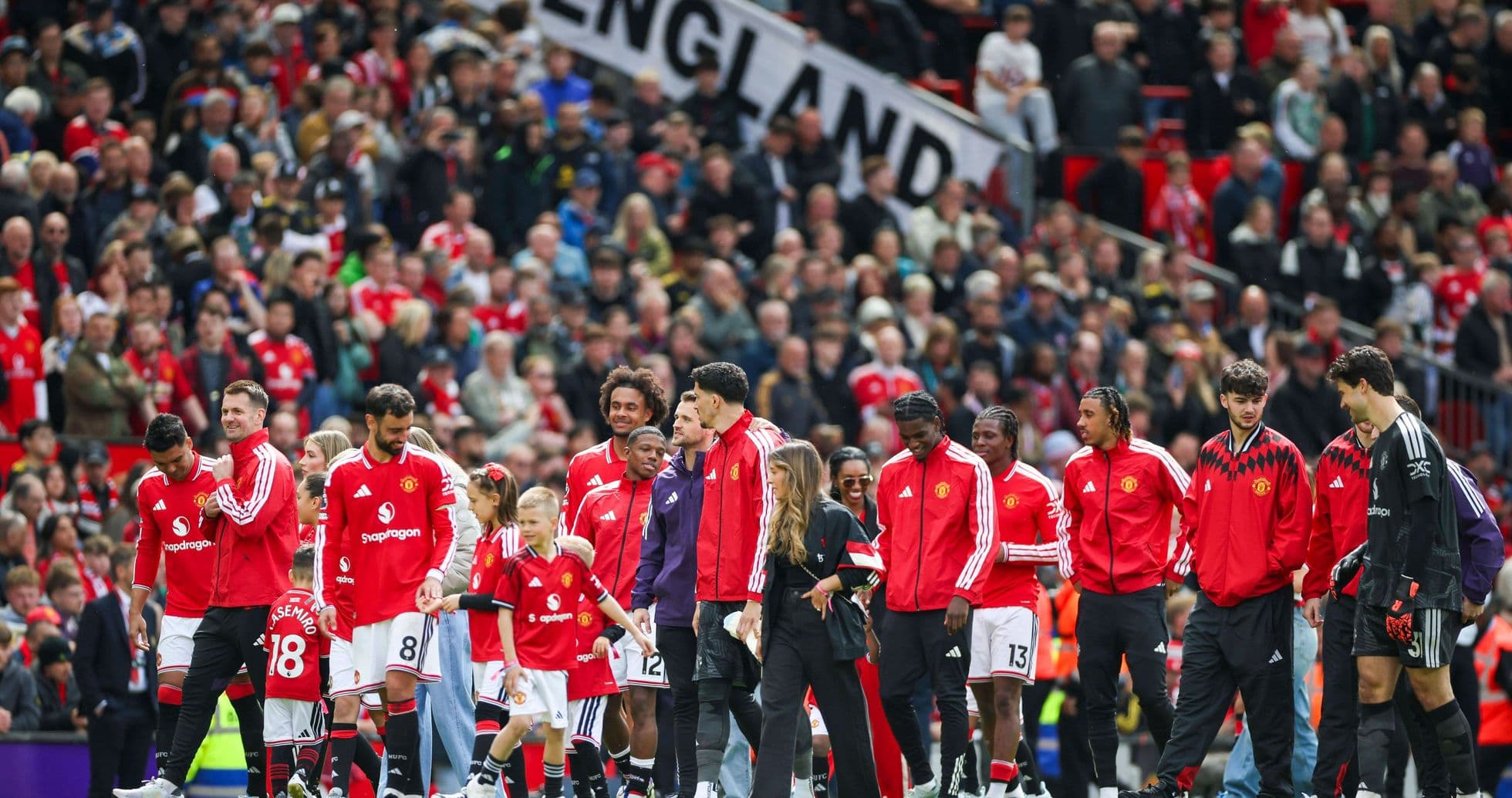 Manchester United players entering the field with fans