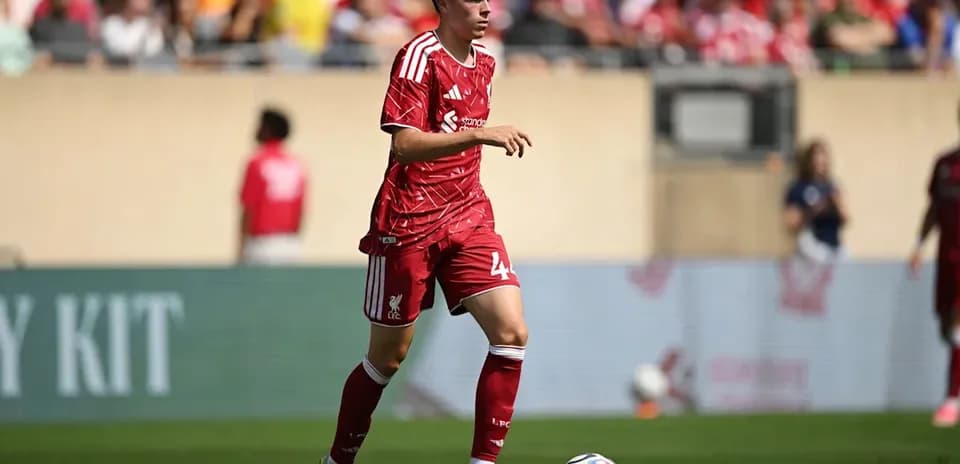 Liverpool player dribbling ball during match