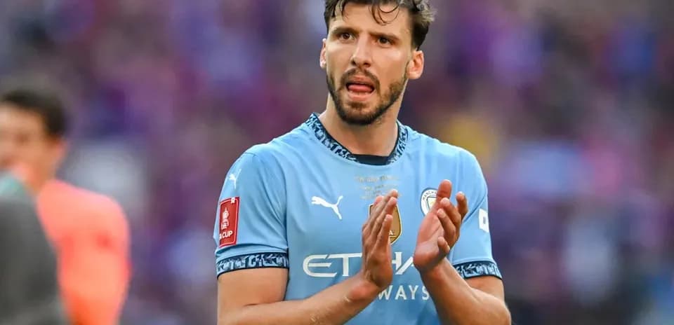 Player applauding in Manchester City jersey during match