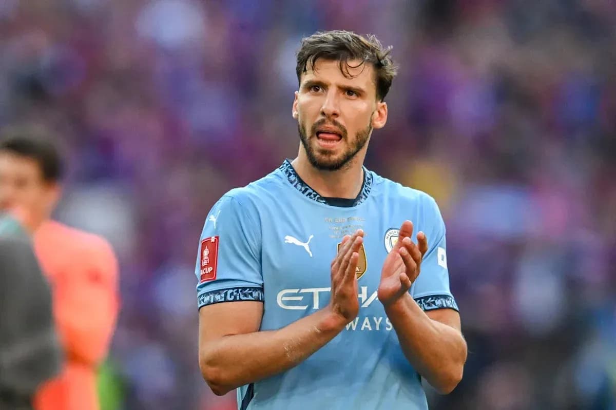 Player applauding in Manchester City jersey during match