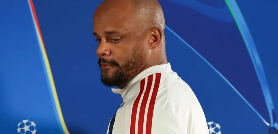Person in sports attire at press conference backdrop